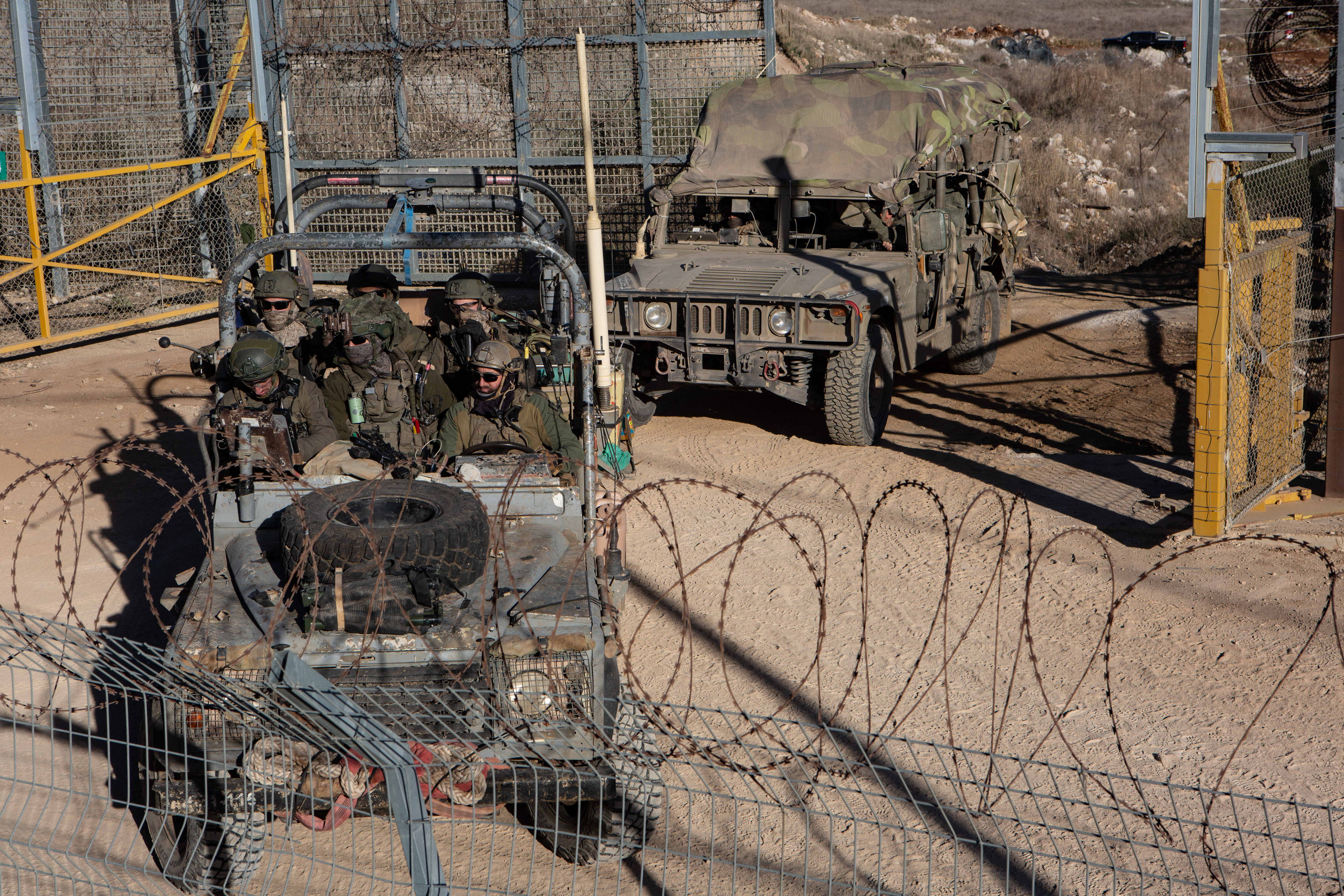 Israeli troops and military vehicles cross in and out of Syria through a gate in the boundary fence near the Druze village of Majdal Shams on Golan Heights, on December 15, 2024. Photo: Reuters/Mati Milstein/NurPhoto
