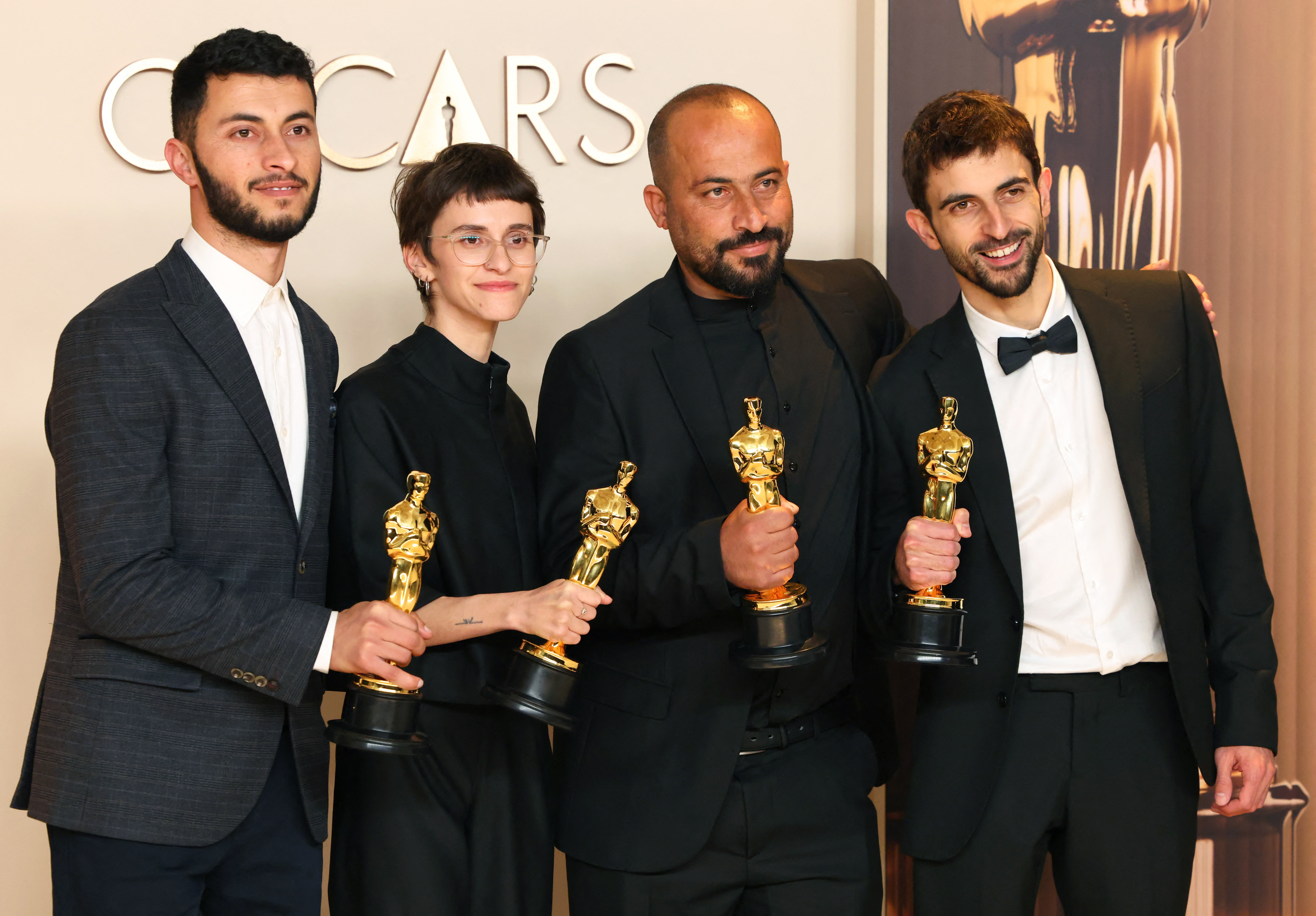 Basel Adra, Rachel Szor, Hamdan Ballal and Yuval Abraham pose with the Oscar for Best Documentary Feature Film for 