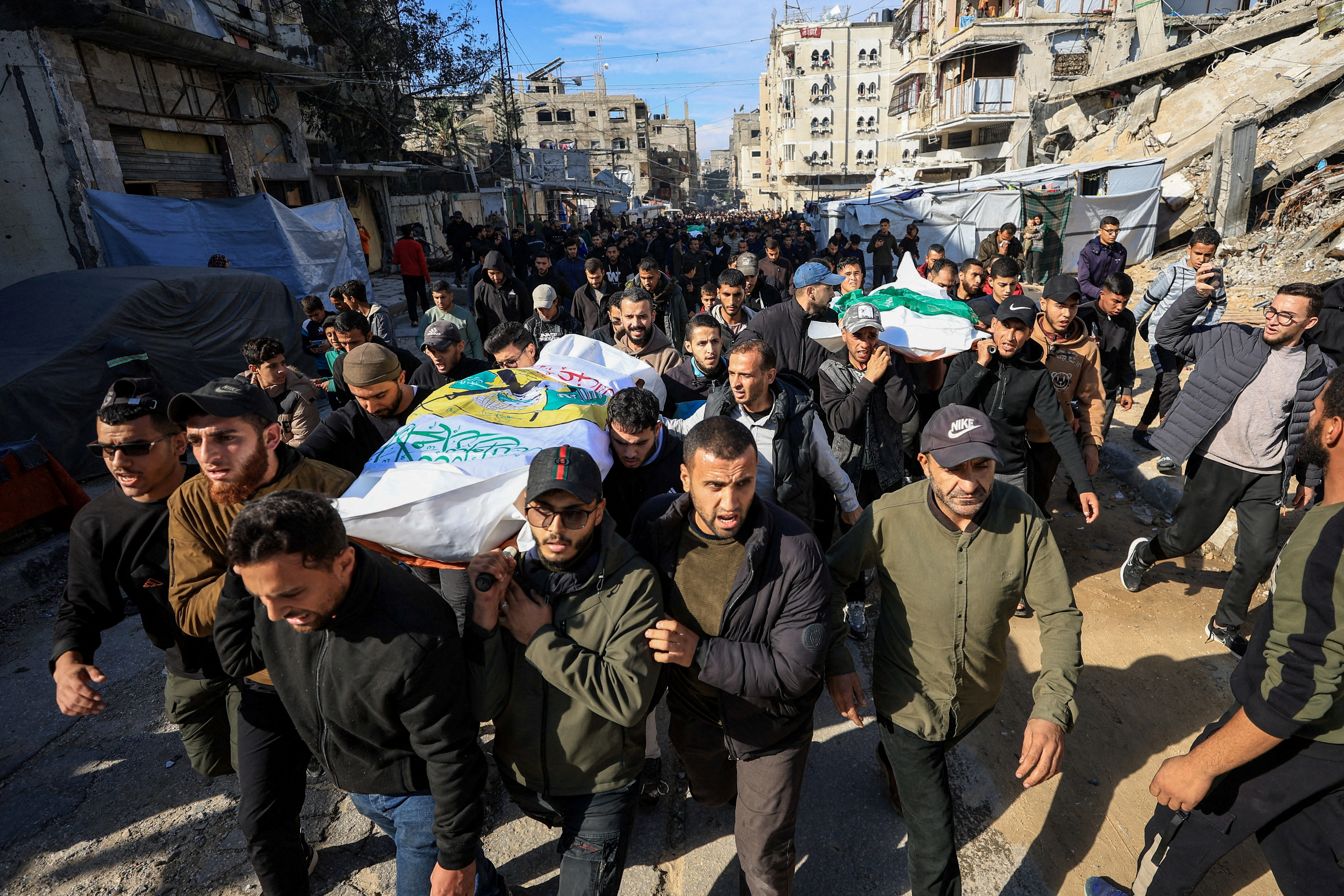 Mourners carry bodies during the funeral of Hamas's senior commander Raed Saed and his aides, who were killed in an Israeli strike a day earlier, in Gaza City, December 14, 2025. Photo: Reuters Connect by Dawoud Abu Alkas