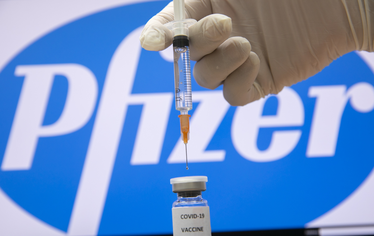 A photo illustration of a syringe and and a bottle reading 
