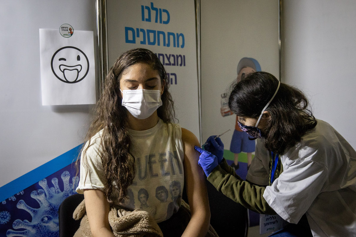Young Israelis receives a Covid-19 vaccine injection, at Clalit Covid-19 vaccination center in Jerusalem, on February 4, 2021. Photo by Yonatan Sindel/Flash90