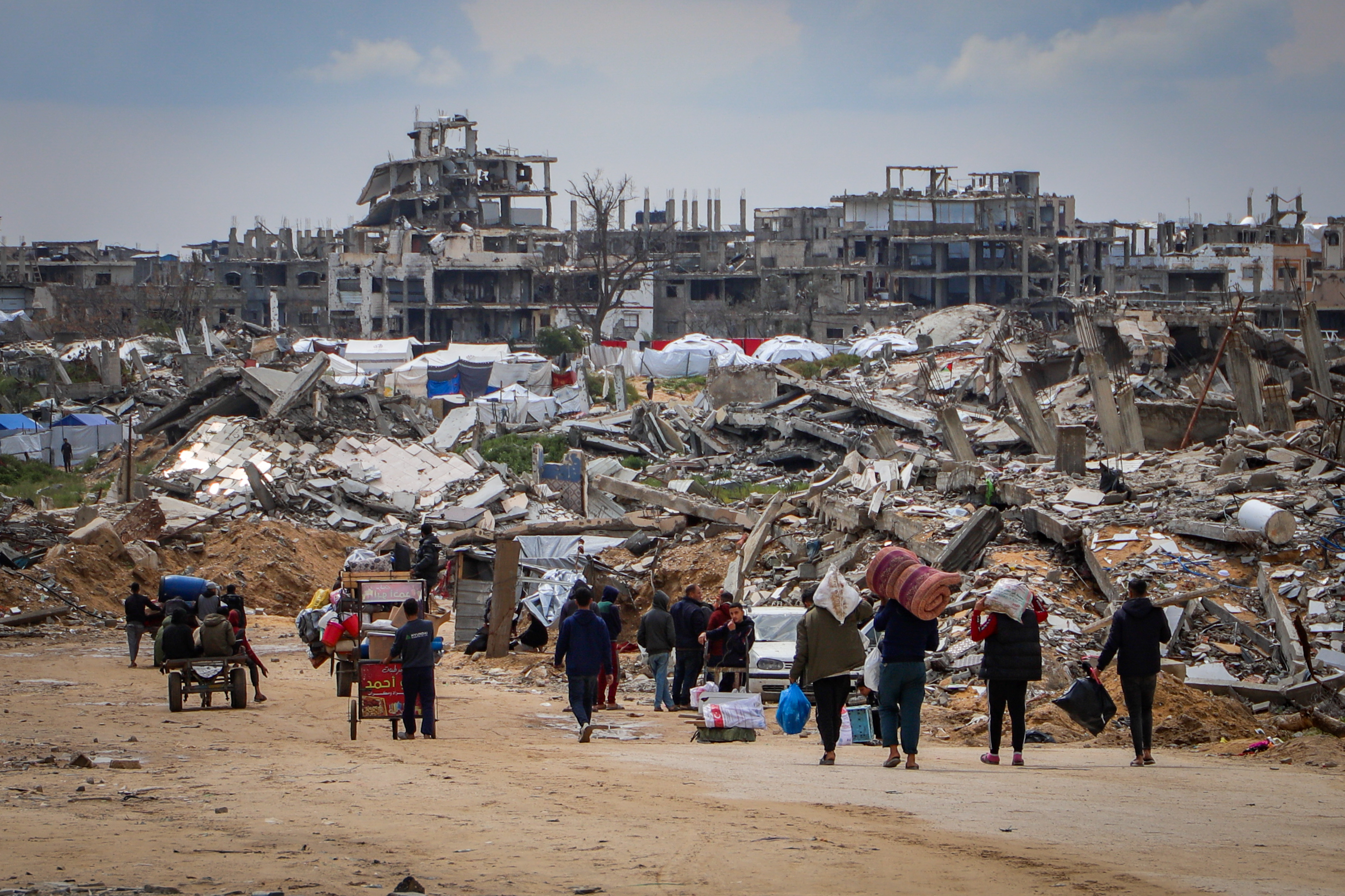 Palestinians seen with their belongings after fleeing from their homes in Beit Lahia, in the northern Gaza Strip, on March 22, 2025. Photo by Khalil Kahlout/ Flash90